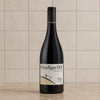 A bottle of Paradigm Hill Shiraz Coonawarra Peninsula red wine, set against a tiled kitchen backsplash background.