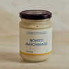 A glass jar of Portside Bonito Mayonnaise with a cream-colored label and dark lid, set against a neutral, light beige background.